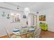 Charming dining area with glass-top table and coastal decor at 3705 E Bay Dr # 115, Holmes Beach, FL 34217
