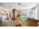 Bedroom with queen bed, access to bathroom, and ceiling fan at 1477 Park Beach Cir # 13, Punta Gorda, FL 33950