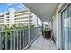 Screened balcony with wicker furniture and ocean view at 1477 Park Beach Cir # 13, Punta Gorda, FL 33950