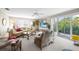 Bright living room features comfy seating, large windows, and access to a balcony at 1477 Park Beach Cir # 13, Punta Gorda, FL 33950