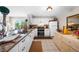 Kitchen with granite countertops, white cabinets, and stainless steel appliances at 1477 Park Beach Cir # 13, Punta Gorda, FL 33950