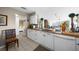 White kitchen with granite counters, microwave, and view into bedroom at 1477 Park Beach Cir # 13, Punta Gorda, FL 33950