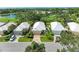 Aerial showing a row of houses near a golf course and lake at 8736 52Nd E Dr, Bradenton, FL 34211