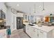 Modern kitchen with white cabinets, large island and stainless steel appliances at 5228 Bentgrass Way, Bradenton, FL 34211