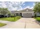 One-story home with gray siding, stone accents and a two-car garage at 5228 Bentgrass Way, Bradenton, FL 34211