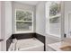 Relaxing bathroom featuring a soaking tub and large windows at 5228 Bentgrass Way, Bradenton, FL 34211