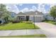 One-story home with gray siding, stone accents and a two-car garage at 5228 Bentgrass Way, Bradenton, FL 34211