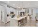 Modern kitchen with white cabinets, large island and stainless steel appliances at 5228 Bentgrass Way, Bradenton, FL 34211