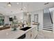 Bright kitchen features a center island with a sink and white cabinets at 5228 Bentgrass Way, Bradenton, FL 34211
