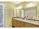 Double vanity bathroom with marble countertops and updated fixtures at 2517 Glebe Farm Close # H-2, Sarasota, FL 34235