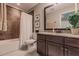 Bathroom with granite countertop and dark wood vanity at 4694 Royal Dornoch Cir, Bradenton, FL 34211