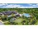 Aerial view of a clubhouse offering a pool and lush landscaping surrounded by mature trees at 5917 Laurelcrest Gln, Palmetto, FL 34221