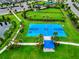 Aerial view of the blue basketball court with covered seating in a well-maintained park at 5917 Laurelcrest Gln, Palmetto, FL 34221