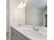Modern bathroom features a double sink vanity with chrome faucets and white countertops at 5917 Laurelcrest Gln, Palmetto, FL 34221