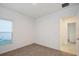 Bedroom with neutral carpet, window with blinds, and doorway to the hall at 5917 Laurelcrest Gln, Palmetto, FL 34221