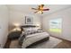 Cozy bedroom features a ceiling fan, neutral decor, and a window at 5917 Laurelcrest Gln, Palmetto, FL 34221