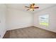 Bedroom features neutral color scheme, ceiling fan, and natural light from the window at 5917 Laurelcrest Gln, Palmetto, FL 34221