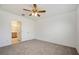 Bedroom with neutral carpet and paint, ceiling fan and an ensuite bathroom at 5917 Laurelcrest Gln, Palmetto, FL 34221