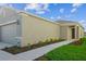 Side exterior of home featuring sidewalk and trimmed landscaping leading to the front door at 5917 Laurelcrest Gln, Palmetto, FL 34221