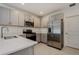 Modern kitchen features stainless steel appliances, light gray cabinets and quartz countertops at 5917 Laurelcrest Gln, Palmetto, FL 34221