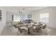Elegant dining and living area featuring natural light, modern furnishings, and tile floors at 5917 Laurelcrest Gln, Palmetto, FL 34221