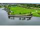 Aerial view of a pond with a walking path and seating in a meticulously landscaped community at 5917 Laurelcrest Gln, Palmetto, FL 34221