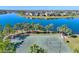 Enjoy a community basketball court with palm trees and lake views at 9622 Channing Hill Dr, Ruskin, FL 33573