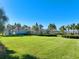 Expansive green lawn with community center in the background at 9622 Channing Hill Dr, Ruskin, FL 33573