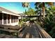 Wooden walkway through lush tropical landscaping at 2517 Glebe Farm Close # H-2, Sarasota, FL 34235