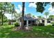 Private backyard with screened patio and lush lawn at 2517 Glebe Farm Close # H-2, Sarasota, FL 34235