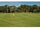 Putting green with flags and lush grass at 2517 Glebe Farm Close # H-2, Sarasota, FL 34235