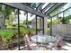 Screened patio with table and chairs, overlooking the backyard at 2517 Glebe Farm Close # H-2, Sarasota, FL 34235