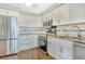Modern kitchen featuring stainless steel appliances and granite countertops at 2517 Glebe Farm Close # H-2, Sarasota, FL 34235