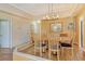 Elegant dining room with wood floors and a modern chandelier at 2517 Glebe Farm Close # H-2, Sarasota, FL 34235