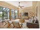 Spacious living room with hardwood floors and access to a patio at 2517 Glebe Farm Close # H-2, Sarasota, FL 34235
