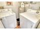Convenient laundry room with washer, dryer, and water heater at 2517 Glebe Farm Close # H-2, Sarasota, FL 34235
