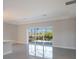 Open living room with large sliding glass doors and pool view at 12390 Cedar Pass Trl, Parrish, FL 34219