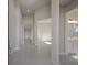 Bright and spacious hallway with tile flooring, leading to various rooms at 12390 Cedar Pass Trl, Parrish, FL 34219