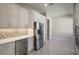 Modern kitchen with white cabinets and stainless steel appliances at 12390 Cedar Pass Trl, Parrish, FL 34219
