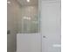 Modern glass shower with grey tile surround at 12390 Cedar Pass Trl, Parrish, FL 34219