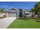 Single-story home with two-car garage and nicely landscaped yard at 12390 Cedar Pass Trl, Parrish, FL 34219