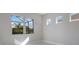 Bright bedroom featuring large windows and a view of the outdoors at 12390 Cedar Pass Trl, Parrish, FL 34219