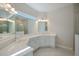 Double vanity bathroom with a large mirror and separate shower at 12390 Cedar Pass Trl, Parrish, FL 34219