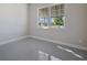 Spacious bedroom with large window and grey tile floor at 12390 Cedar Pass Trl, Parrish, FL 34219
