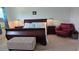 Main bedroom with sleigh bed and a comfy armchair at 7410 64Th E St, Palmetto, FL 34221