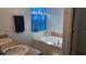 Bathroom with a bathtub, double vanity, and granite countertops at 7410 64Th E St, Palmetto, FL 34221