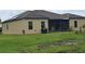 Tan house exterior with solar panels and a screened patio at 7410 64Th E St, Palmetto, FL 34221