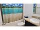 Bathroom with tub and shower, vanity, and tropical shower curtain at 7410 64Th E St, Palmetto, FL 34221