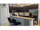 Modern kitchen with dark cabinetry, granite counters, and stainless steel appliances at 7410 64Th E St, Palmetto, FL 34221