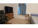 Bedroom with a twin bed, desk, and large TV at 7410 64Th E St, Palmetto, FL 34221